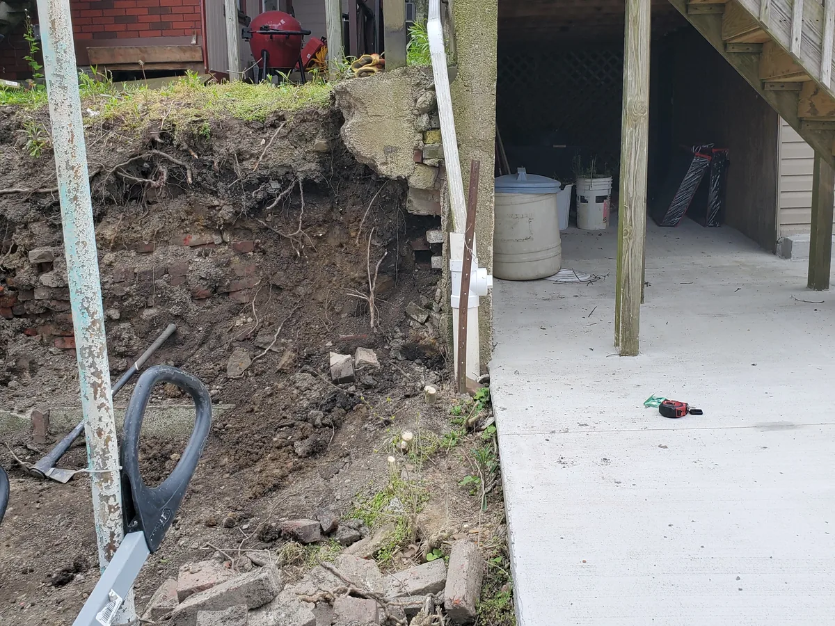 New concrete walk poured along a dug-out bank beside a house