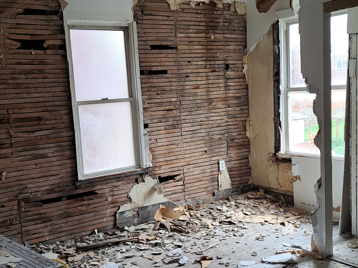 Interior wall with the plaster and lath torn off down to the framing