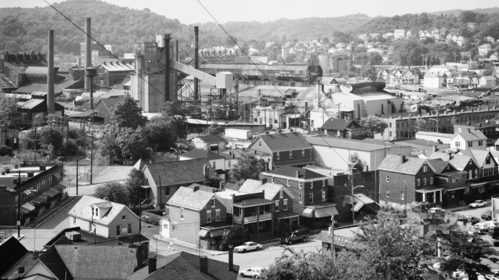 Jeannette, PA seen from a hill facing north: older brick and frame houses in the foreground and factory stacks beyond