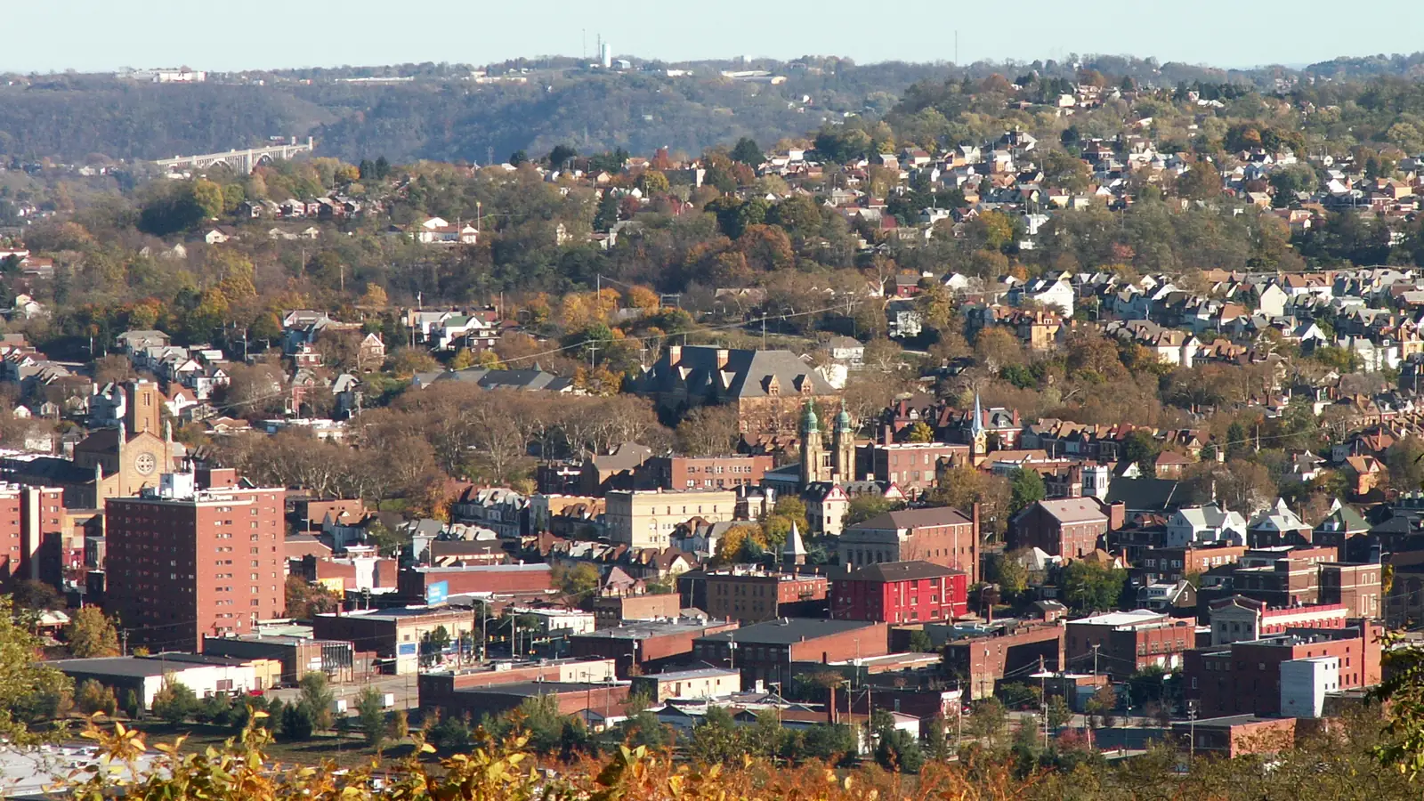 Munhall and Homestead, PA seen from the hillside: older brick blocks, church towers and houses climbing the slope